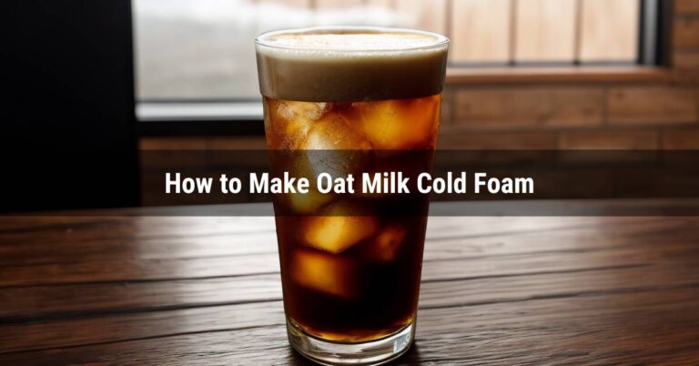 Oat Milk Cold Foam on top of cold brew in a glass with ice